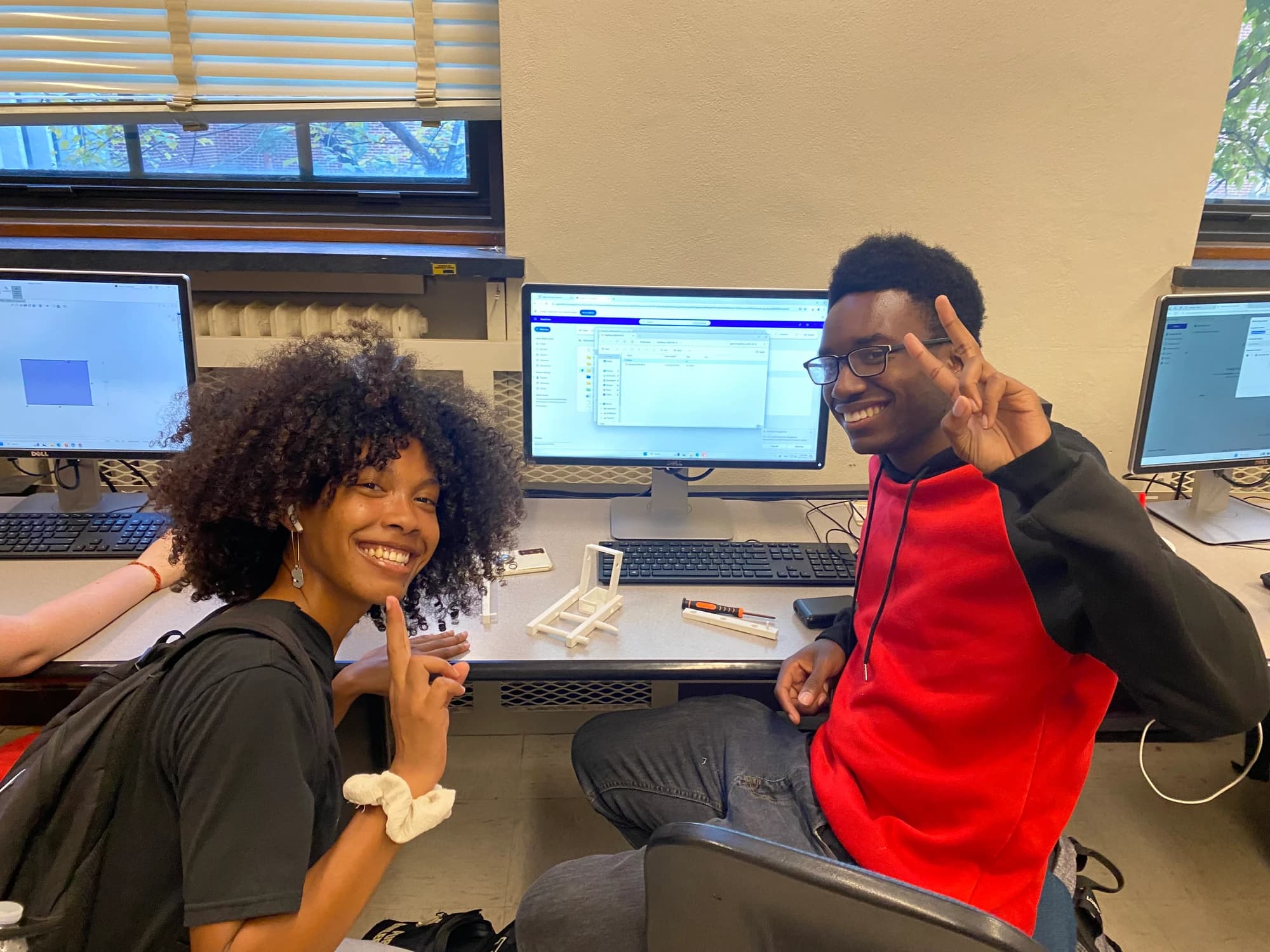 Two HRC members collaborating on software in the lab