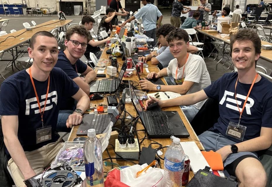 Four University of Zagreb students with their laptops and hardware at StarkHacks